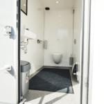 Toilet trailer booth, door open.